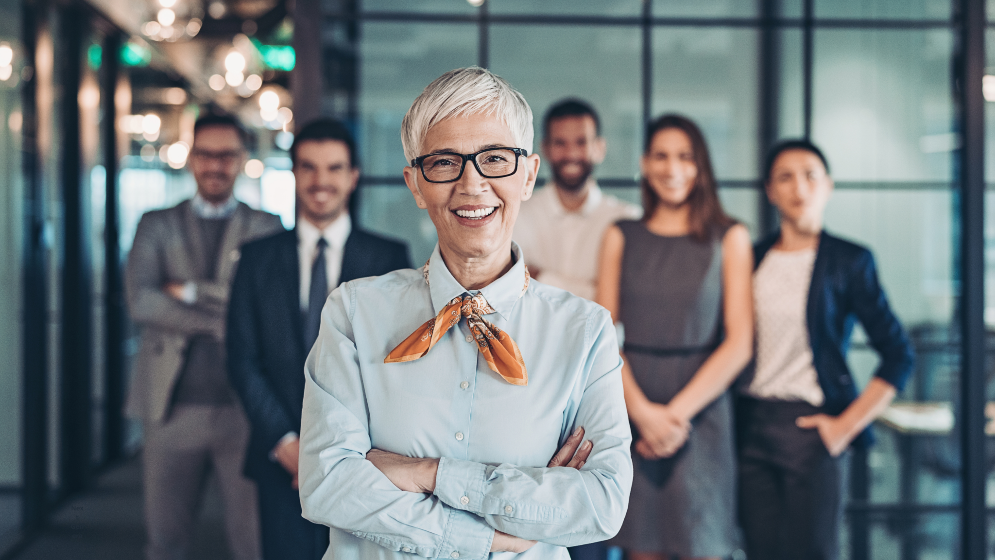 A group of professionals in a collaborative meeting, representing the development of the next generation of organizational leaders.