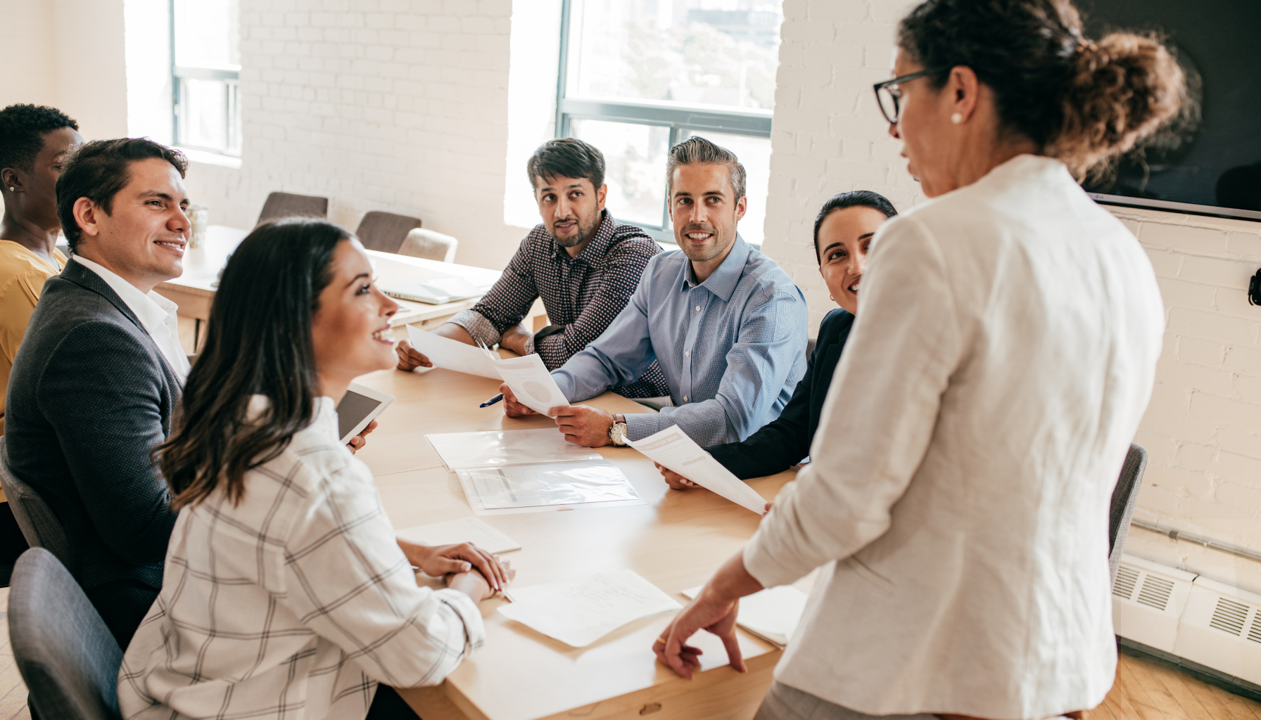 A group of managers practicing new leadership behaviors in a development session.